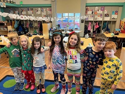 adams students wearing pajamas, lined up with arms on each other's shoulders