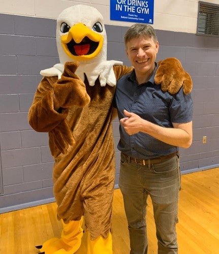 Principal Doug Sohn and Adams Eagle mascot